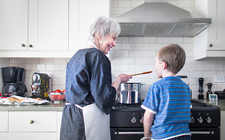 Grandmother cooking with grandchild.