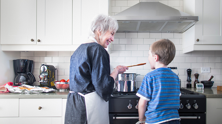 Grandmother cooking with grandchild.