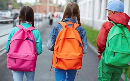 Kids walking with backpacks.