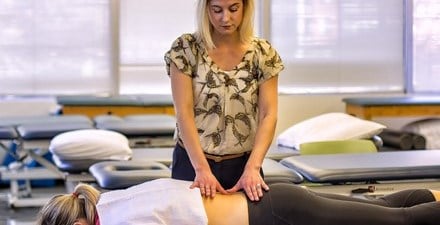 A physical therapist using hands-on therapy for back pain.