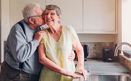 Older couple in kitchen.