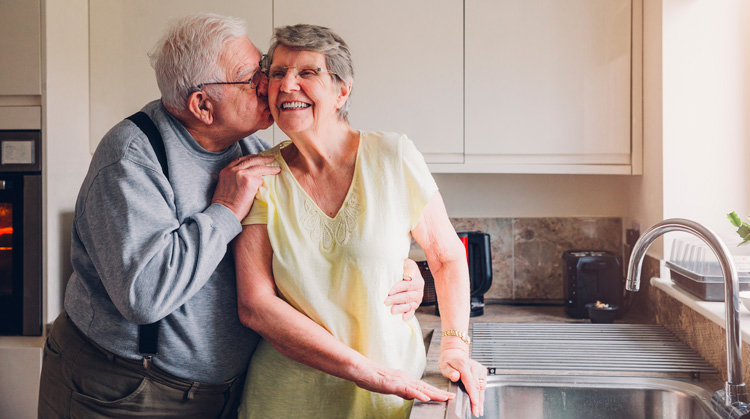 Older couple in kitchen.