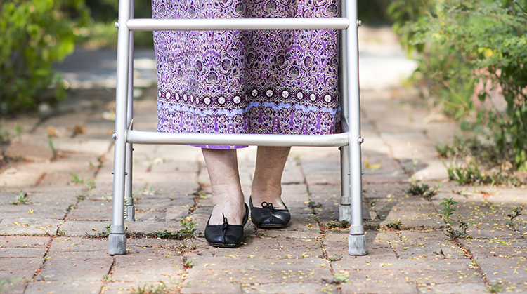 An older adult using a walker.