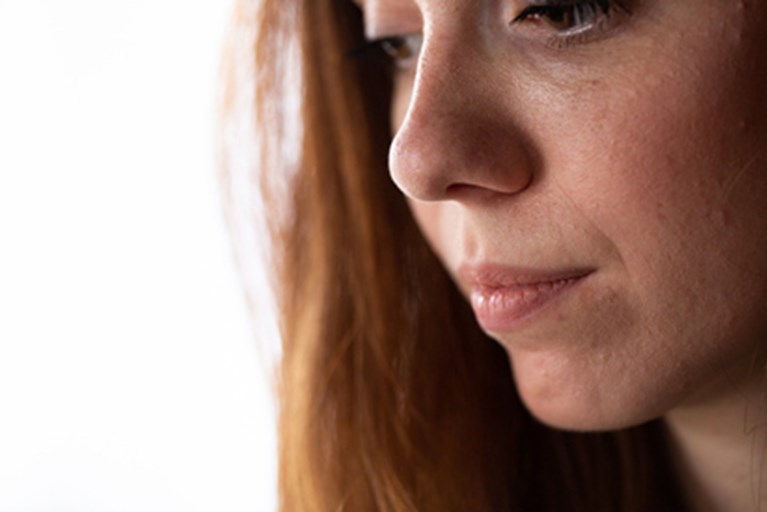 A young woman looking down.