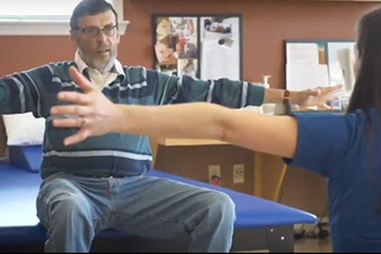 A man with Parkinson's disease doing physical therapy exercises.
