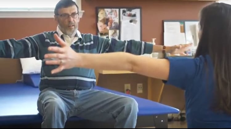 A man with Parkinson's disease doing physical therapy exercises.