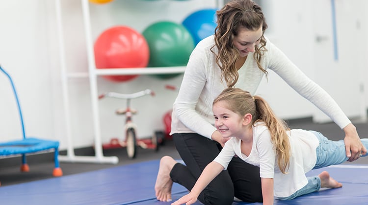 Physical therapist working with a child