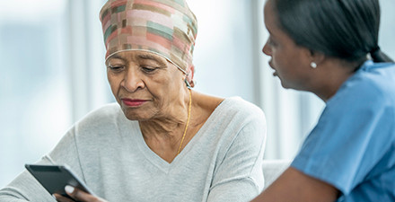 A physical therapist educates a cancer survivor on the benefits of exercise.