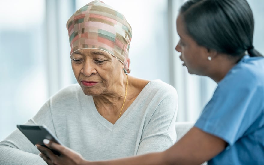 A physical therapist educates a cancer survivor on the benefits of exercise.