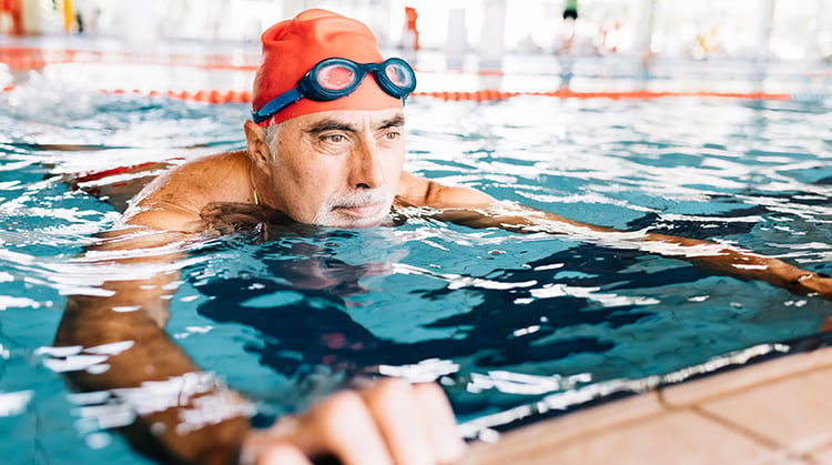 Man exercising in pool.