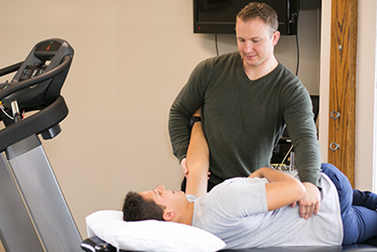 Physical therapist treating someone for back pain