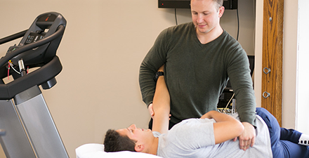 Physical therapist treating someone for back pain