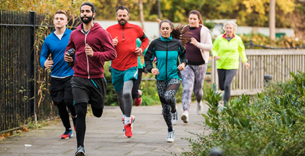 A group of people running outdoors.