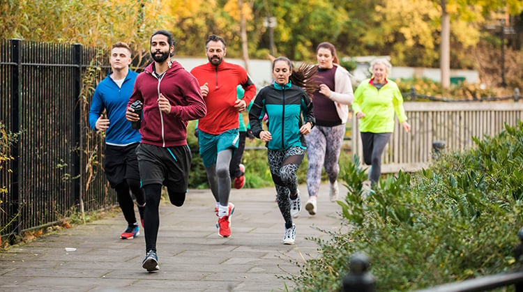 A group of people running outdoors.