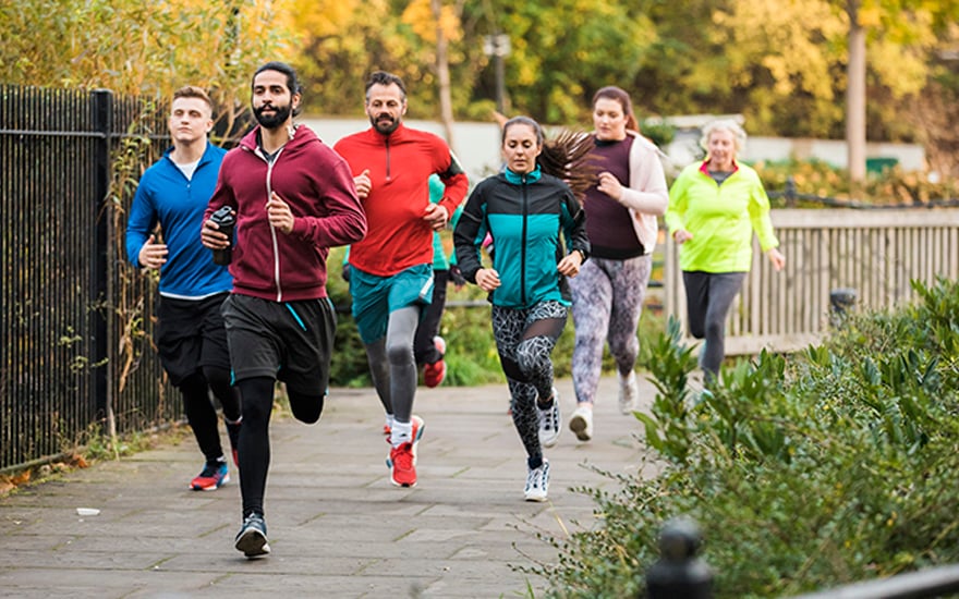 A group of people running outdoors.