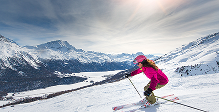 A woman skis down a mountain