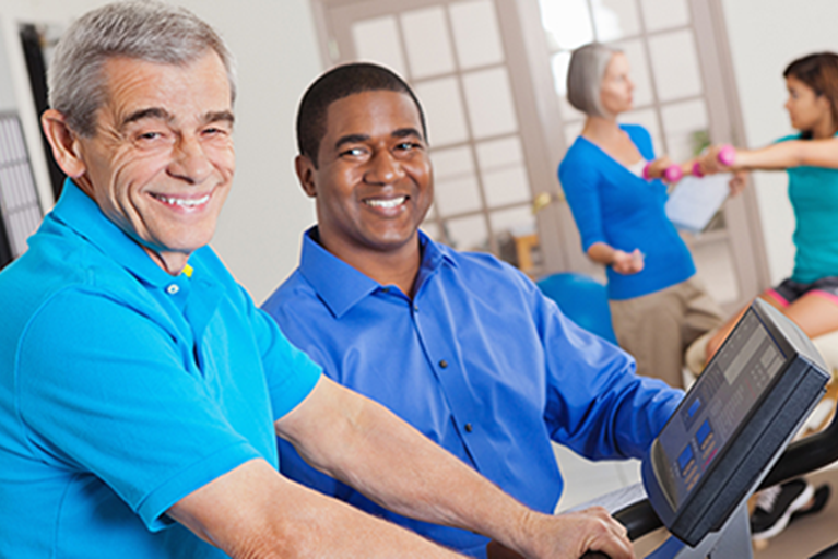 A Physical Therapist working with a man on a Treadmill