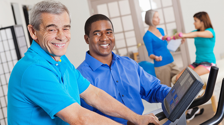 A Physical Therapist working with a man on a Treadmill