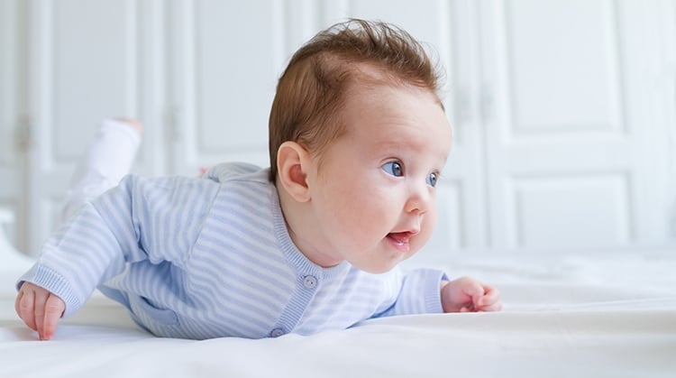 Baby on stomach for tummy time.