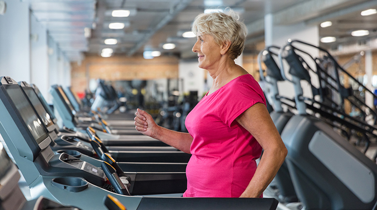 Older adult walking on treadmill.