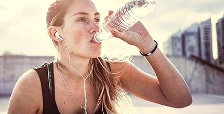 Woman drinking water after a workout.