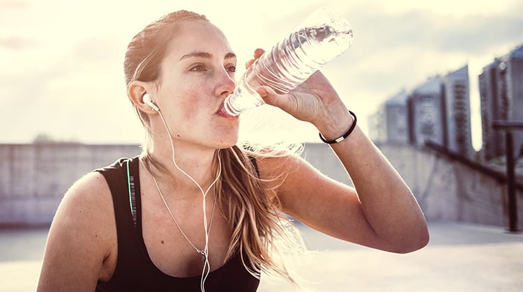 Woman drinking water after a workout.